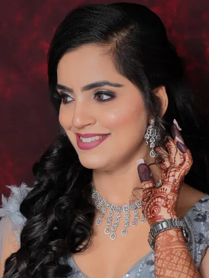 A close-up of a happy client, showing off her party makeup. The smokey eye and pink lip combination is a classic choice for any celebration.