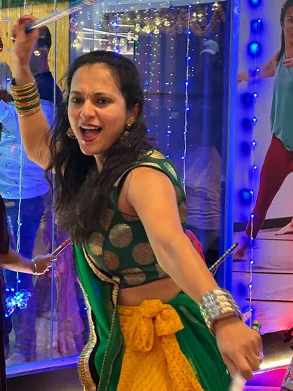 Here I am in my element, leading the group with high energy during a dandiya sequence. My passion for the dance is infectious and encourages everyone to participate.