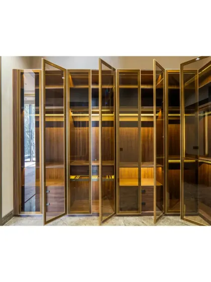 With the doors open, the closet's warm interior lighting is revealed. Every shelf and drawer is designed to feel like a little discovery, making the daily routine of getting dressed a special experience.