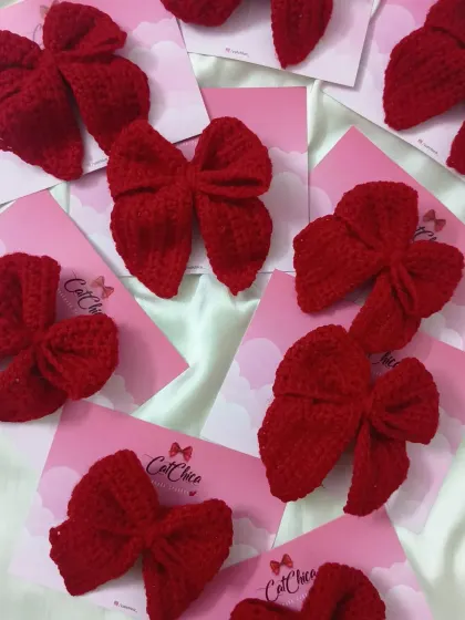 A batch of our classic red crochet sailor bows, a timeless accessory for girls of all ages.