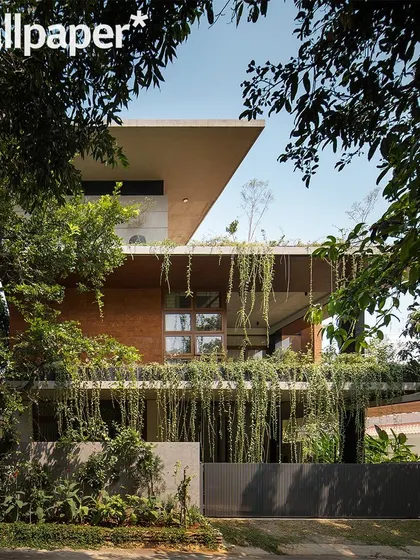 The front view of the house, framed by trees, as published in Wallpaper*.