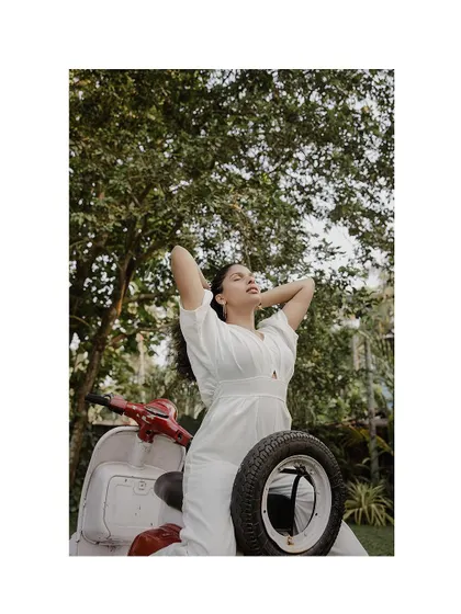 A stylish solo portrait of the bride-to-be with a vintage scooter.