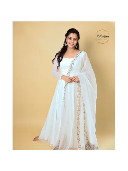 The flow and grace of the white gown are captured in this full-length shot.