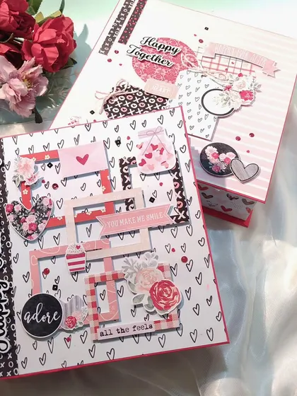 Two anniversary scrapbooks, each with a unique design but a shared romantic theme. This shows the variety I can offer for couple gifts.