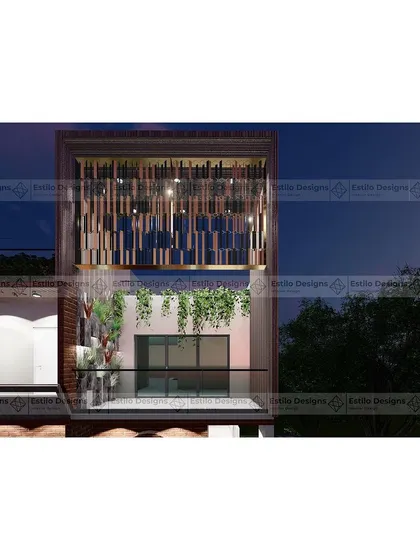 A close-up detail of the Twin House facade at night. This view highlights the intricate metal screen on the upper level, which provides privacy while creating a beautiful light pattern, adding a decorative element to the contemporary design.