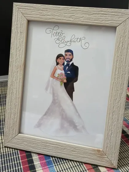 The final framed version of the custom wedding portrait, showing how a digital illustration becomes a beautiful physical keepsake.
