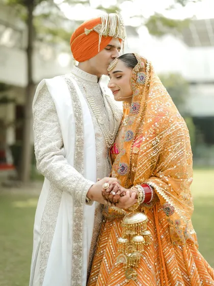 A tender forehead kiss, a moment of quiet assurance. I focus on these gentle gestures that speak volumes about a couple's love and respect for one another.