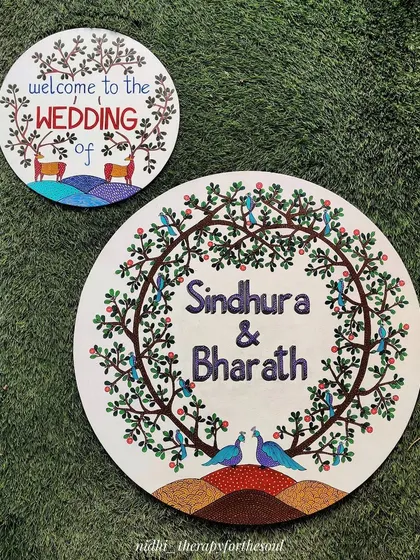 Here are the two pieces I created for the wedding: a large name board for the couple and a smaller welcome sign. Both are painted in the same Gond art style to create a cohesive look for the event decor.