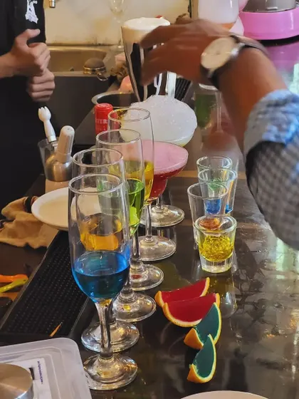 A lineup of our molecular creations, from colorful layered shots to drinks with foam and caviar, ready for a party.