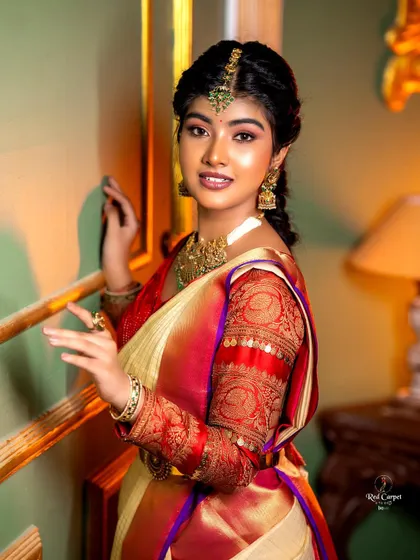A beautiful profile of Amrutha Prem, highlighting the detailed brocade work on the blouse and her traditional South Indian jewelry.