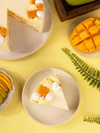 A top-down shot of the mango cake and a slice, showing the full context of the delicious dessert.