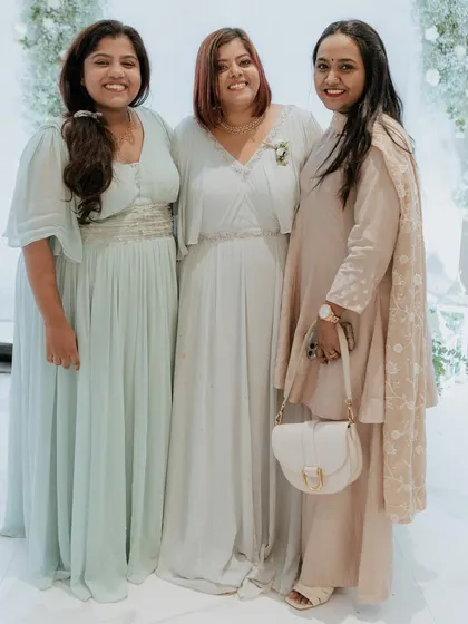 Three lovely ladies dressed in a coordinated pastel palette. Each outfit, from the pleated gown to the embroidered salwar kameez, was tailored to their individual style.
