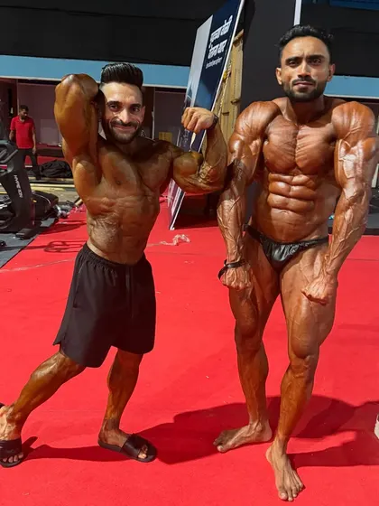 Side-by-side comparison, showing different strengths in our physiques. My online coaching helps clients identify and improve their weak points.