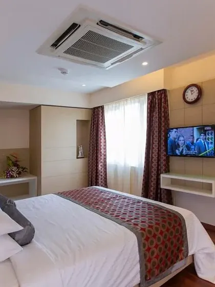 We design hotel rooms to be a home away from home. This angle shows the integrated wardrobe and entertainment unit, demonstrating our approach to creating seamless, built-in furniture that meets all of a guest's needs.