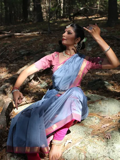 A graceful, seated pose in the woods, part of a brand collaboration that blended the beauty of the saree with the expressiveness of Kathak.