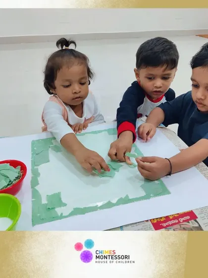 Our youngest learners engage in a tearing and pasting art activity. This simple craft is excellent for strengthening hand muscles and developing coordination.