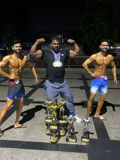The result of teamwork and relentless effort. Posing with my two champions and their collection of trophies after the Mr. India competition. When my athletes win, I win.