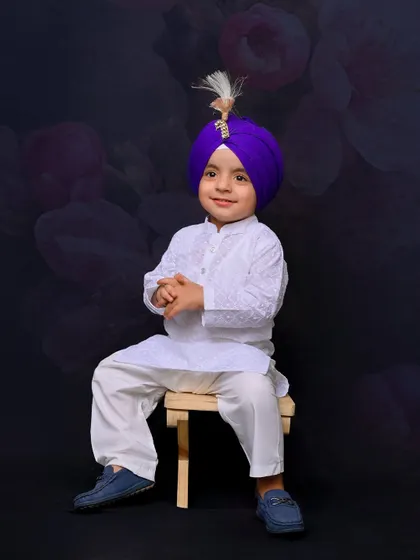 A posed portrait of the young boy, sitting calmly and looking at the camera. This shot demonstrates the ability to capture both playful and formal portraits during a single session.