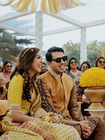 The happy couple enjoying their 'Phoolon ki Holi' celebration, a joyous and colorful event I designed to be full of energy and fun.