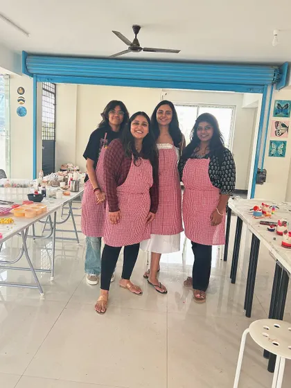 A group of friends wearing aprons, ready for a fun candle making session at our Whitefield studio.