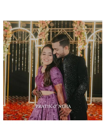 A happy, candid portrait of the couple against their beautifully decorated Sangeet backdrop. Their genuine smiles are the highlight of this shot.