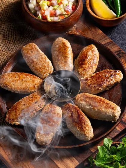 A shot of Galouti kebabs with the "dhungar" smoking method. Capturing unique cooking techniques helps a brand stand out.