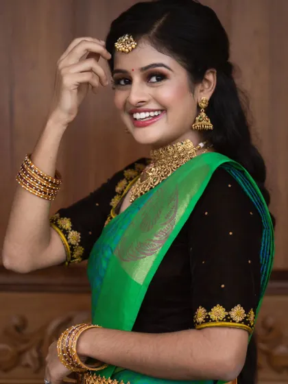 A close-up of this happy client. Her smile says it all. The makeup is clean and radiant, with a focus on her expressive eyes and flawless skin.