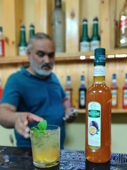 A refreshing passion fruit cocktail, perfectly garnished with a mint sprig. The focus here is on using quality syrups to achieve consistent, bright flavors.