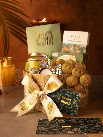 A perfect Diwali hamper featuring a mix of gourmet snacks, festive decor, and a custom-branded ribbon. This gift is designed to delight all the senses.