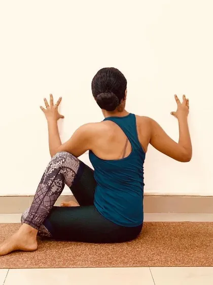 The wall is one of our best props. Here, it's used to deepen the twist in Ardha Matsyendrasana, providing leverage to rotate the torso while keeping the spine long and supported.