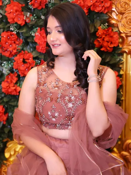 Another beautiful shot against the floral wall. The whole look is soft, romantic, and perfect for a wedding guest.