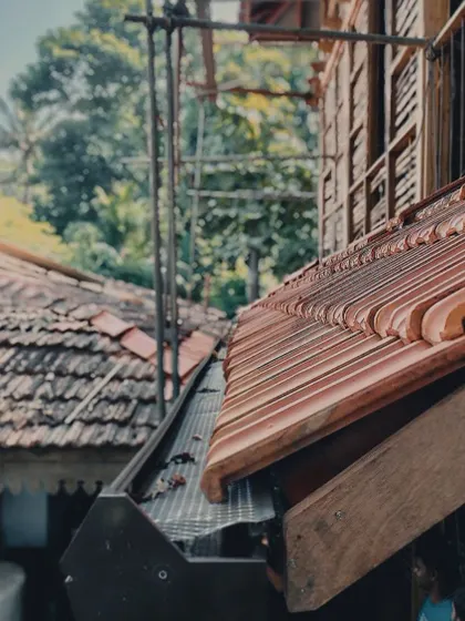 A close-up of the terracotta roof tiles on the Moira cottage. We prioritize using traditional, locally sourced materials that have been proven over centuries to withstand the coastal climate while aging beautifully.