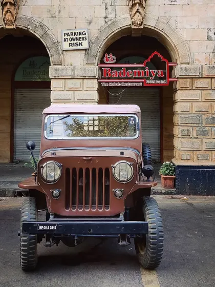 A vintage jeep parked outside our Fort outlet, a perfect match for the rustic and timeless charm of the area and our food.