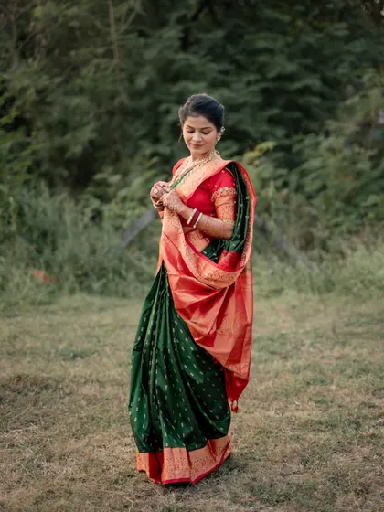 A graceful portrait of the bride-to-be in a traditional saree, captured in a natural, outdoor setting.
