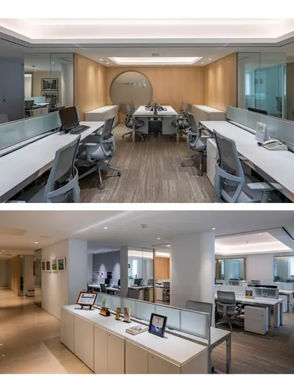 A clean and organized workstation layout with low partitions, promoting easy communication between team members. The neutral color palette with wood accents creates a calm and professional atmosphere.