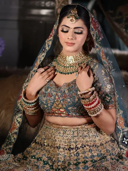 A portrait focusing on the harmony between the makeup and the heavy bridal necklace.
