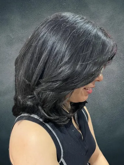 A side view of Ritu's new layered hairstyle.