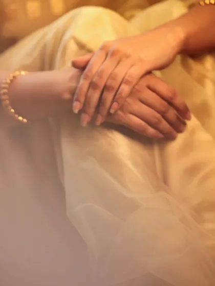 Soft, candid-style portraits of an actress in a simple cream-colored saree. The warm, diffused lighting and relaxed pose create an intimate and gentle mood.