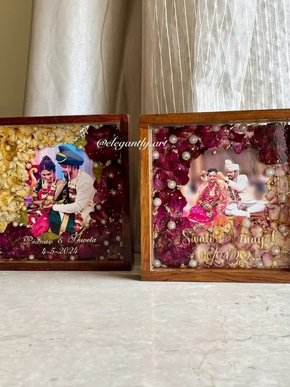 A side-by-side comparison of two 8-inch teakwood frames, each preserving a couple's unique wedding varmala. It shows how different flowers and arrangements create distinct, personal works of art.