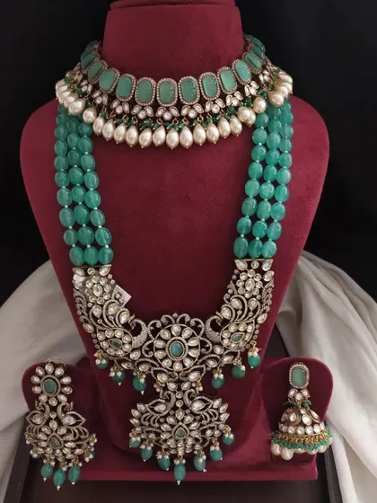 A grand Victorian bridal set in a rich emerald green. This layered set includes a choker, a long necklace with a large pendant, and matching earrings for a complete look.