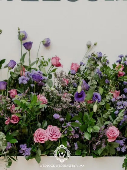 Simple yet elegant details like these chair ribbons and floral arrangements can transform a space. For this reception, we used purple florals and lanterns to create a romantic ambiance.