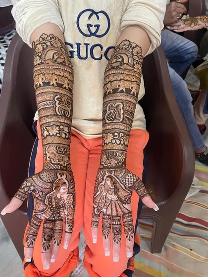 A slightly different angle of the same beautiful Rajasthani bridal design, showing how the patterns wrap around the arms for a complete look.