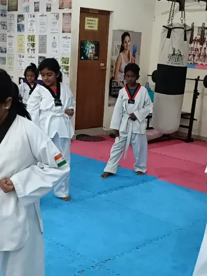 A group of girls focused on their punching technique.