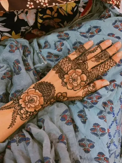 A slightly different angle of the same floral design, showing how the pattern wraps around the side of the hand.