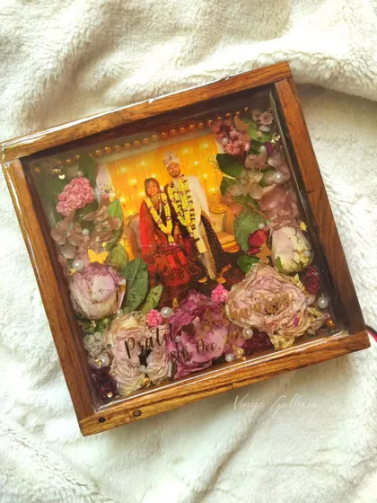 The 8x8 inch lighted frame, which can be used as both a wall-hung piece and table decor.