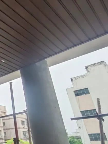 A close-up of our wood-look ceiling cladding installed under a balcony. Whatever your application for outdoor wood, we have the material and expertise to implement it.