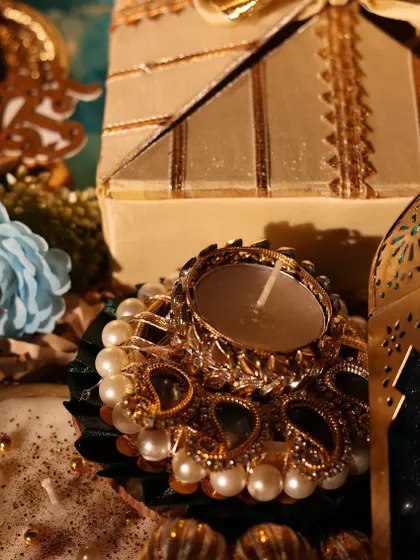 A close-up of a pearl and mirror-work T-light holder, one of the many decorative items I source for my hampers.