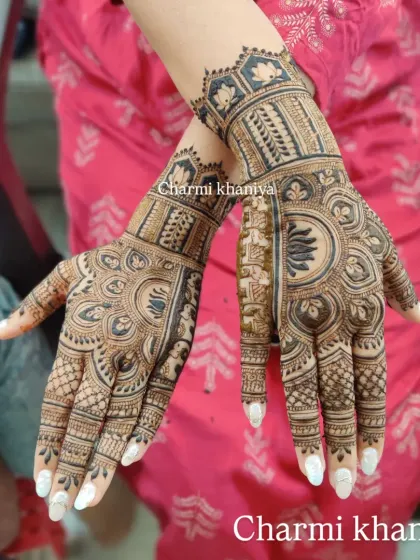 A beautiful design with a mix of floral and geometric patterns. The white nails make the henna look even richer.
