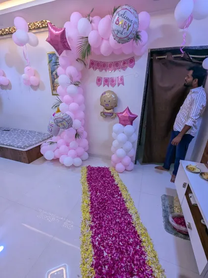 A candid shot showing the scale of the welcome baby decoration within the home, creating a full and celebratory environment for the family.