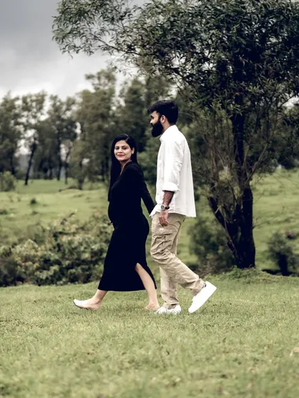 A beautiful shot of the couple taking a stroll through a park. The natural setting and their easy connection make for a lovely, candid portrait.